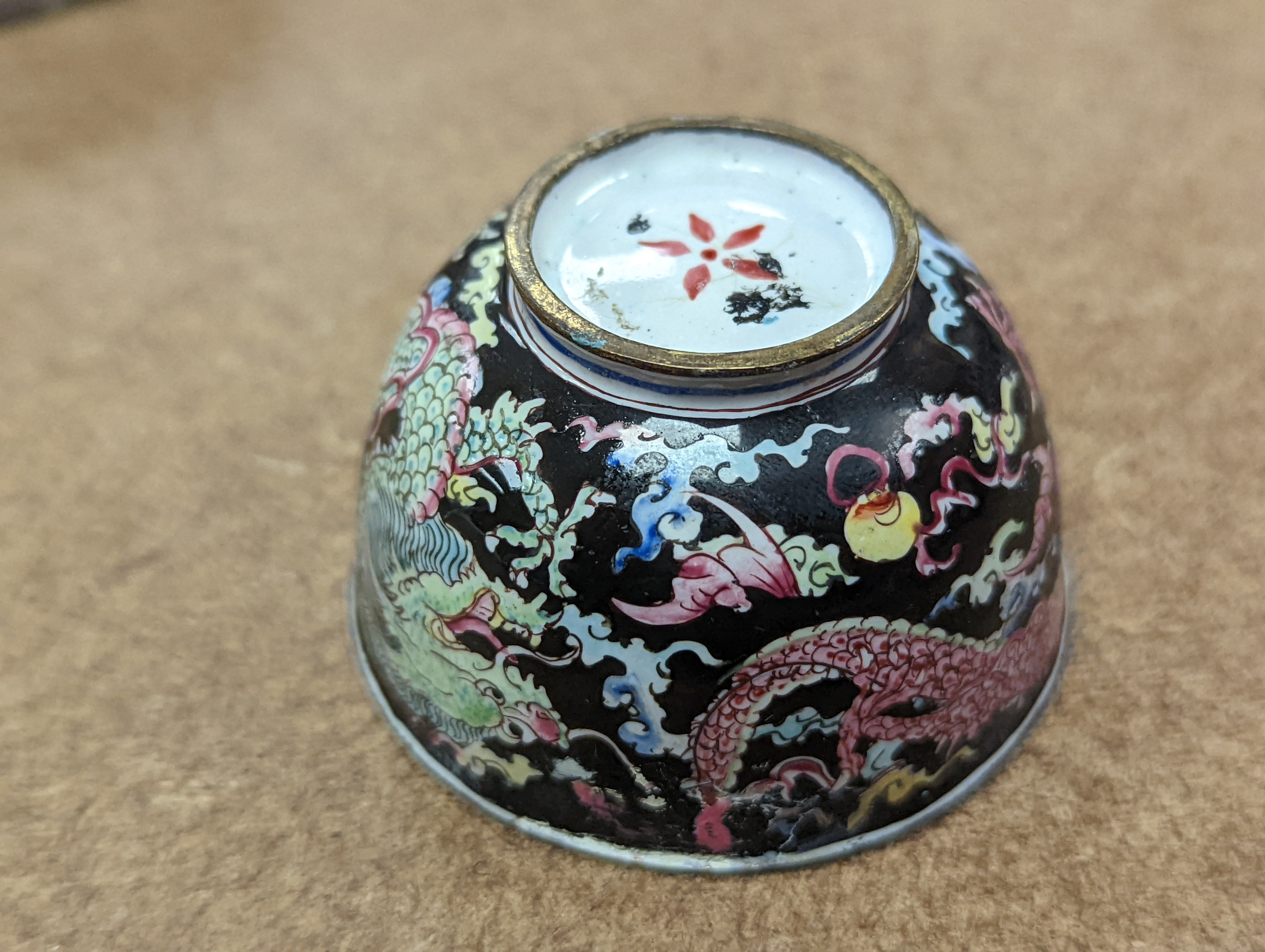 Two 18th century Chinese Canton enamel cups, and a 19th century Canton enamel oval snuff box, 5.8cm